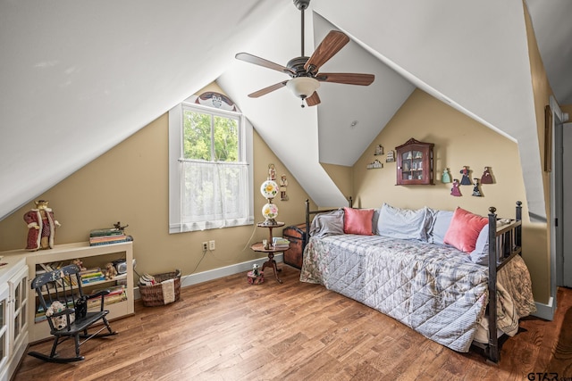 bedroom with hardwood / wood-style flooring, ceiling fan, and vaulted ceiling