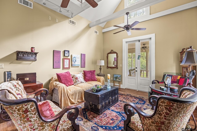 living room with french doors, wood-type flooring, ceiling fan, and high vaulted ceiling