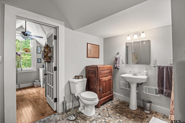 bathroom with hardwood / wood-style flooring, ceiling fan, toilet, and lofted ceiling