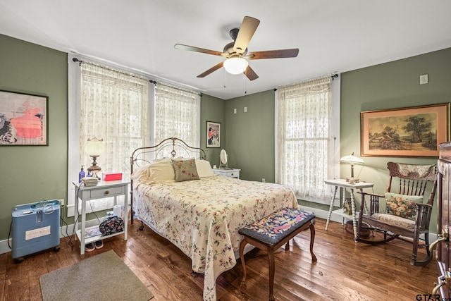 bedroom featuring dark wood-type flooring and ceiling fan