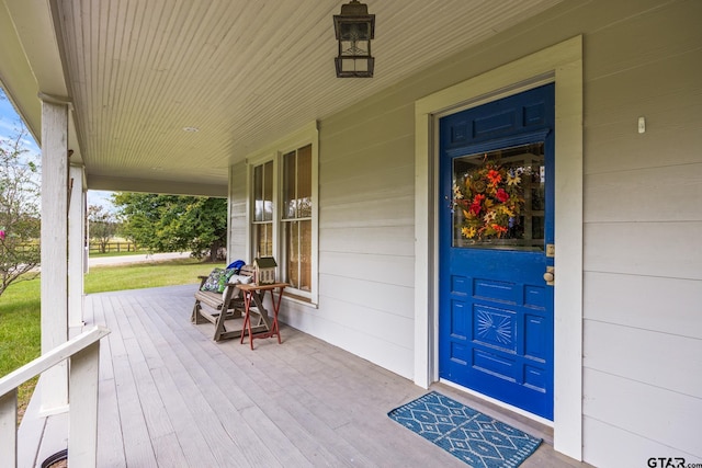 view of exterior entry with covered porch