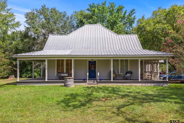 farmhouse inspired home featuring covered porch and a front lawn