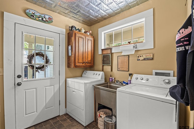 washroom featuring washing machine and dryer and cabinets