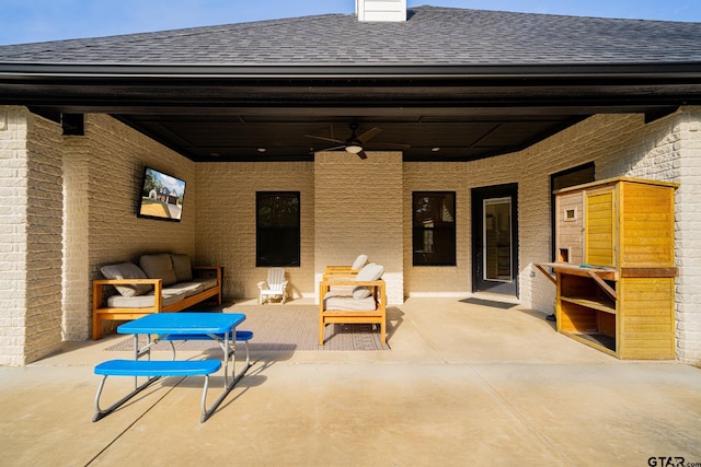 view of patio with ceiling fan and an outdoor living space