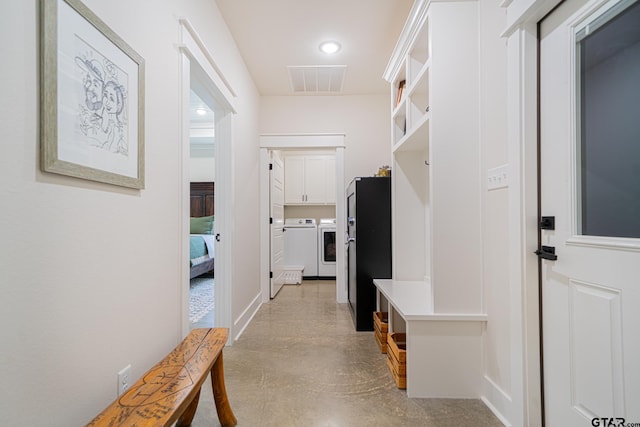 mudroom with separate washer and dryer