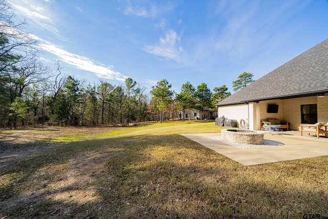 view of yard featuring a patio area and an outdoor fire pit