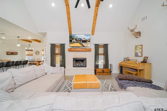 living room with beam ceiling, high vaulted ceiling, and a brick fireplace