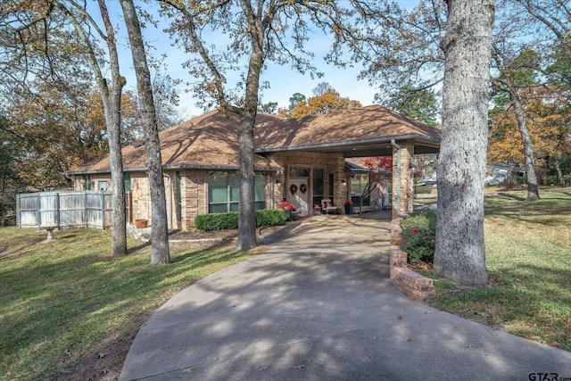 view of front of property with a front lawn and a carport