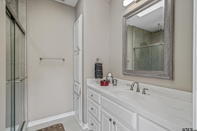 bathroom with tile patterned flooring, vanity, and a shower with shower door