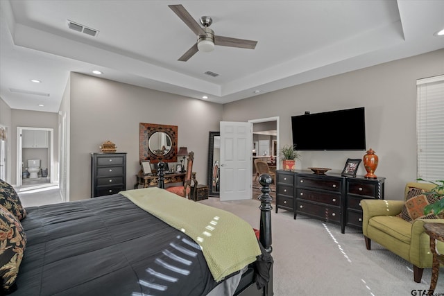 carpeted bedroom featuring a raised ceiling and ceiling fan