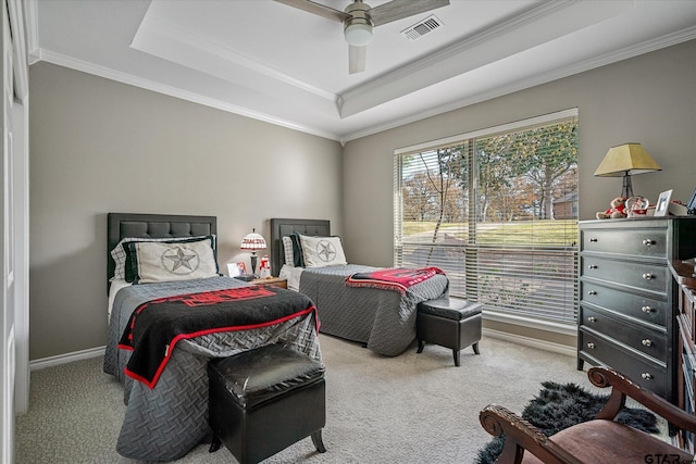 bedroom with carpet, ceiling fan, ornamental molding, and a tray ceiling