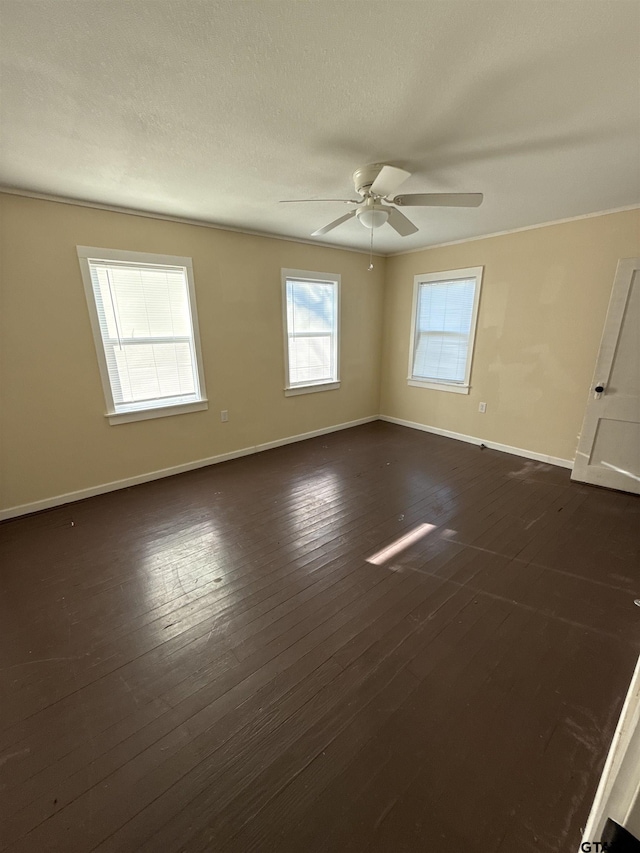 empty room with ceiling fan, a textured ceiling, and dark hardwood / wood-style flooring