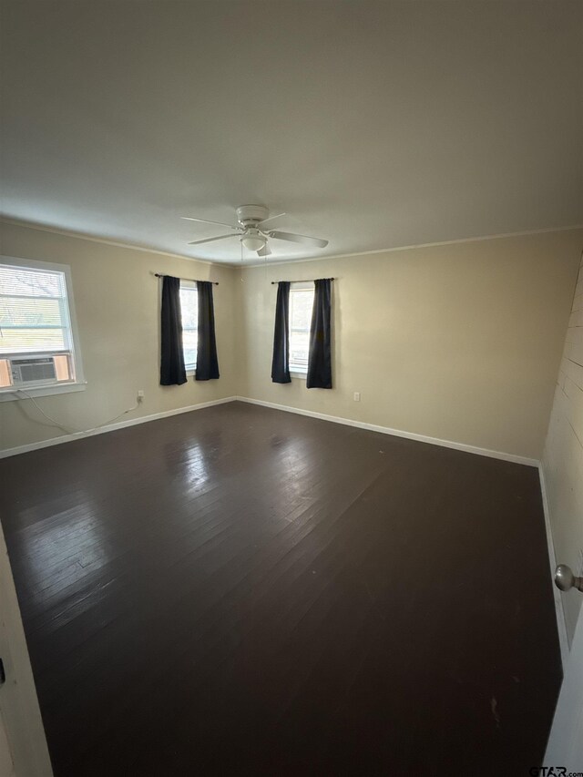 unfurnished room with cooling unit, wood-type flooring, and ceiling fan