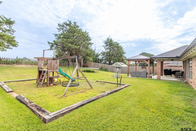 view of jungle gym featuring a trampoline, a gazebo, a patio area, and a lawn