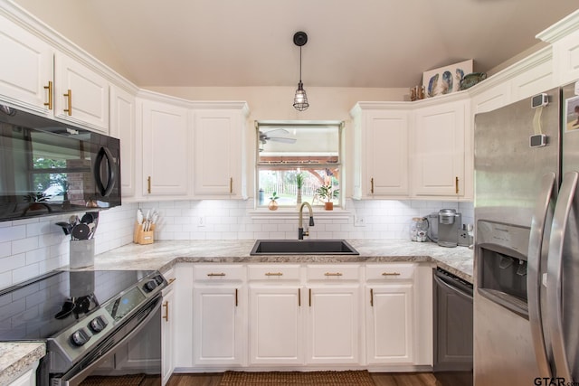 kitchen with decorative light fixtures, sink, white cabinets, decorative backsplash, and stainless steel appliances