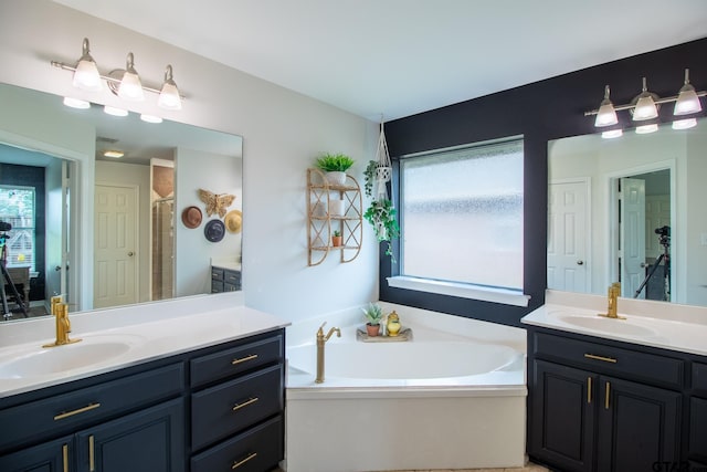 bathroom featuring independent shower and bath and vanity