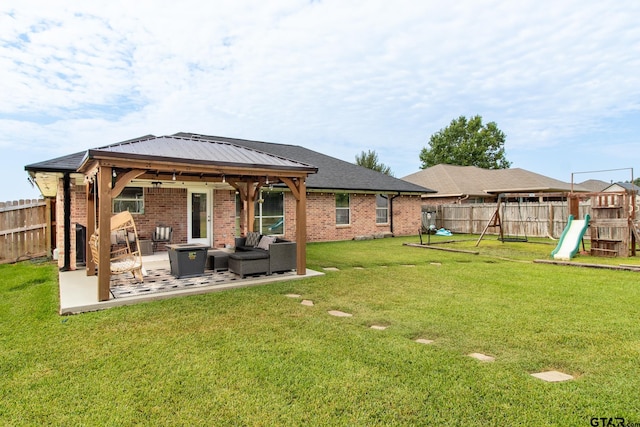 back of property featuring a yard, outdoor lounge area, a patio, and a playground