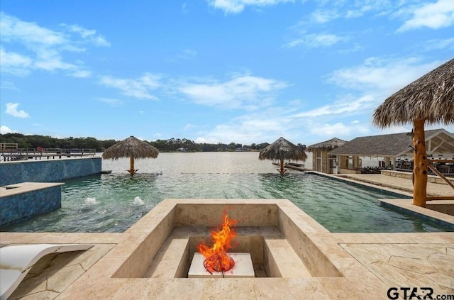 220 Pin Oak Dr, Mabank, TX 75156 - view of swimming pool featuring an outdoor fire pit, an infinity pool, and a water view