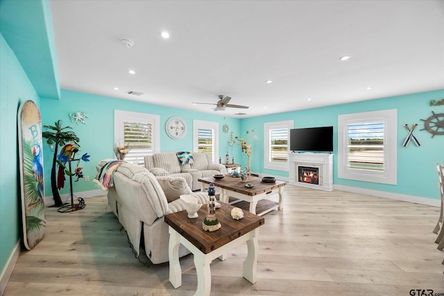 220 Pin Oak Dr, Mabank, TX 75156 - living room featuring light wood-type flooring, a glass covered fireplace, recessed lighting, and ceiling fan