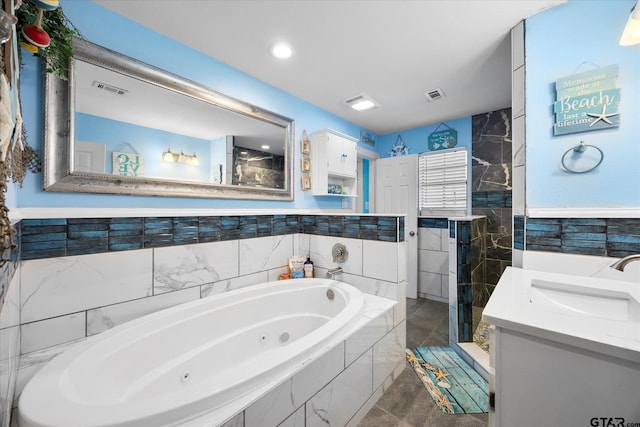 220 Pin Oak Dr, Mabank, TX 75156 - bathroom with a tub with jets, vanity, a shower stall, and tile walls