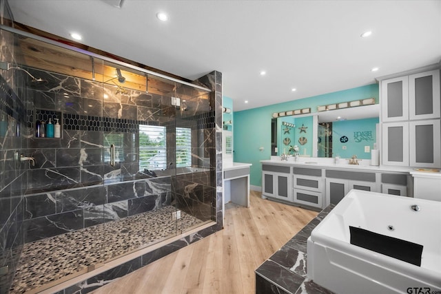 220 Pin Oak Dr, Mabank, TX 75156 - bathroom featuring a jetted tub, a marble finish shower, double vanity, hardwood / wood-style floors, and recessed lighting