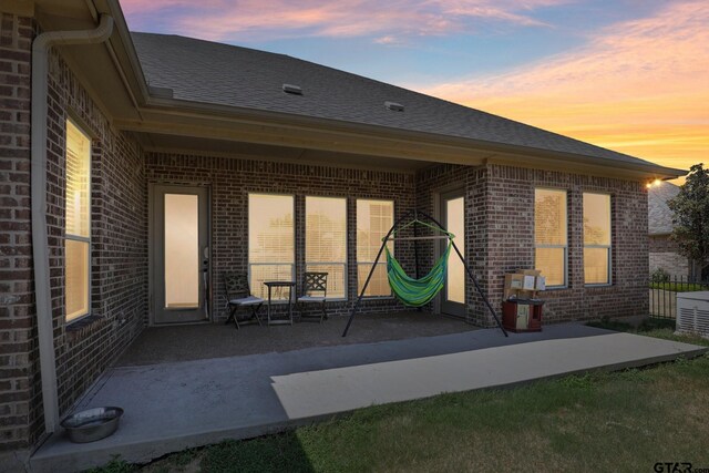3449 Abes Landing Dr, Granbury, TX 76049 - back of house featuring brick siding, a patio, and a shingled roof