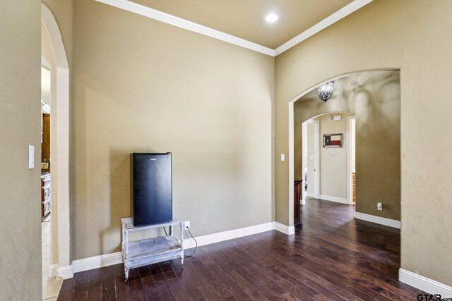 3449 Abes Landing Dr, Granbury, TX 76049 - unfurnished living room with arched walkways, hardwood / wood-style flooring, and ornamental molding
