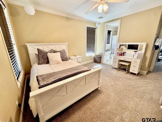 carpeted bedroom with ornamental molding, ensuite bathroom, and ceiling fan