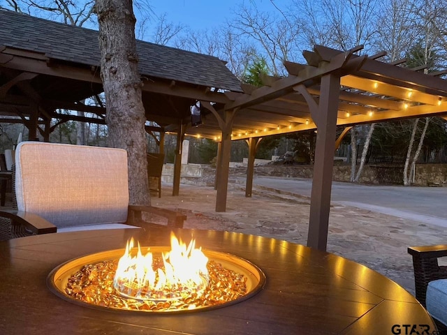 wooden terrace with a pergola and an outdoor fire pit