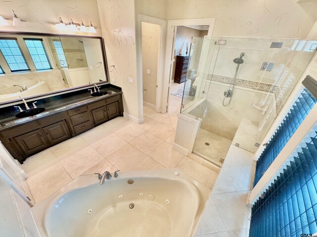 bathroom with vanity, tile patterned floors, and plus walk in shower