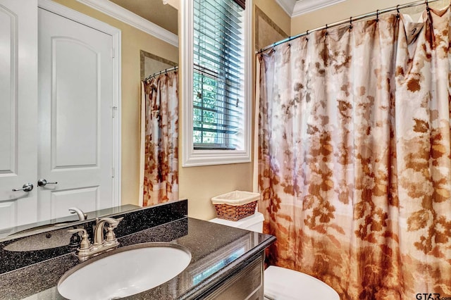 bathroom featuring vanity, ornamental molding, and toilet