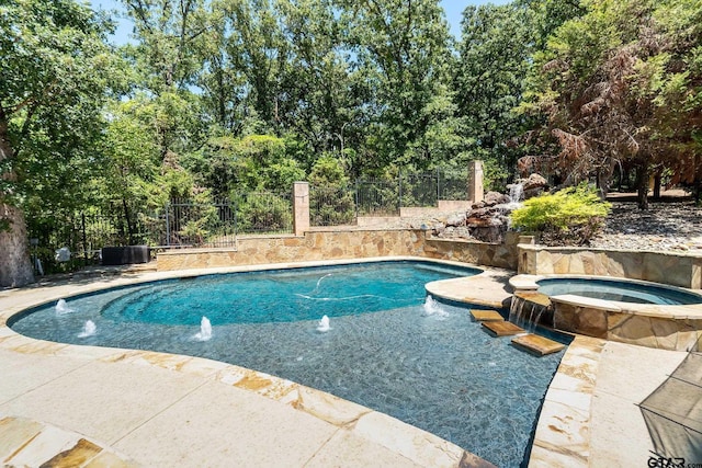 view of swimming pool with an in ground hot tub and pool water feature