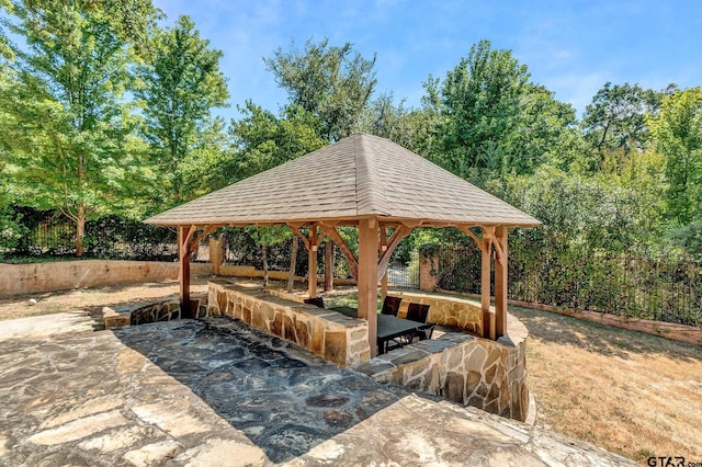 view of property's community with a gazebo and a patio area