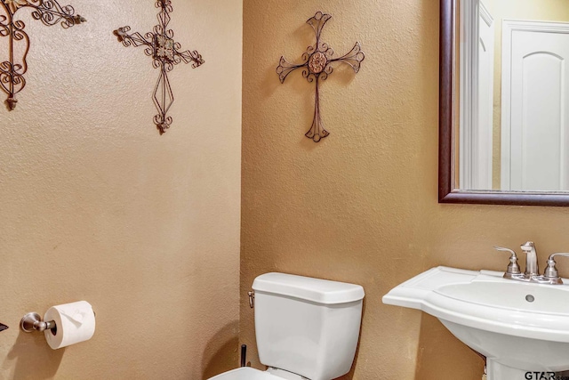 bathroom featuring sink and toilet