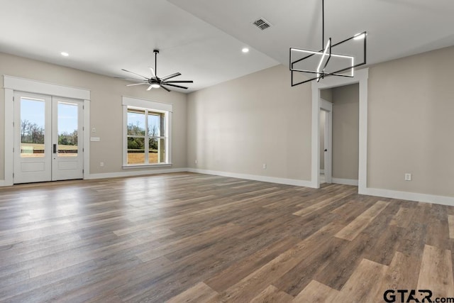 interior space with ceiling fan with notable chandelier, recessed lighting, baseboards, and wood finished floors