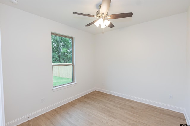 spare room featuring light hardwood / wood-style floors and ceiling fan