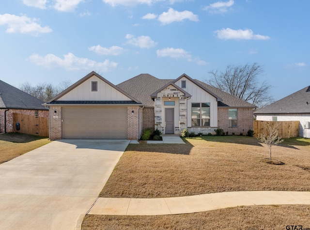 view of front of property featuring a garage and a front lawn