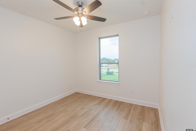 spare room with light hardwood / wood-style flooring, ceiling fan, and a healthy amount of sunlight