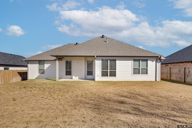 rear view of property featuring a yard and a patio