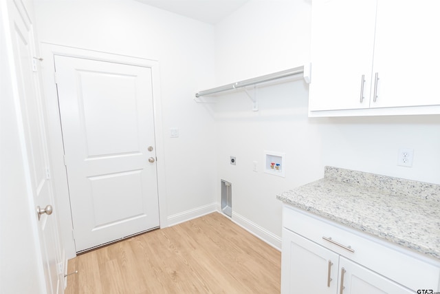 laundry room with washer hookup, light hardwood / wood-style floors, cabinets, and hookup for an electric dryer