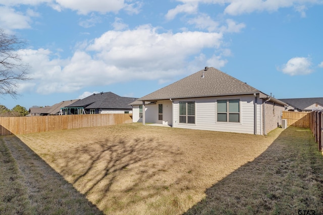 rear view of property featuring a yard