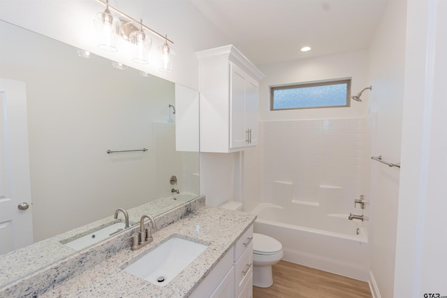 full bathroom featuring vanity, bathing tub / shower combination, hardwood / wood-style flooring, and toilet