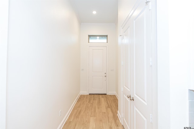 corridor featuring light hardwood / wood-style floors and ornamental molding