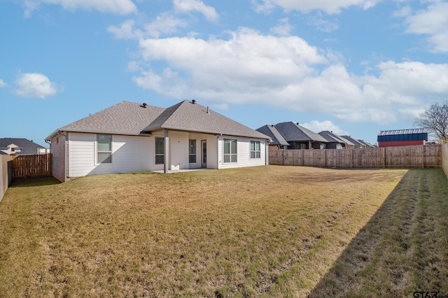 rear view of house with a yard