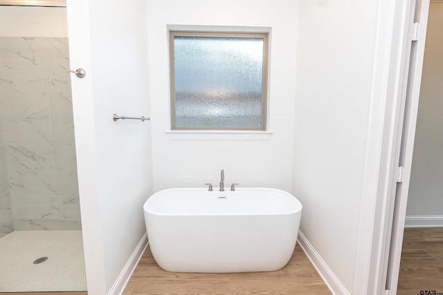 bathroom featuring separate shower and tub and wood-type flooring