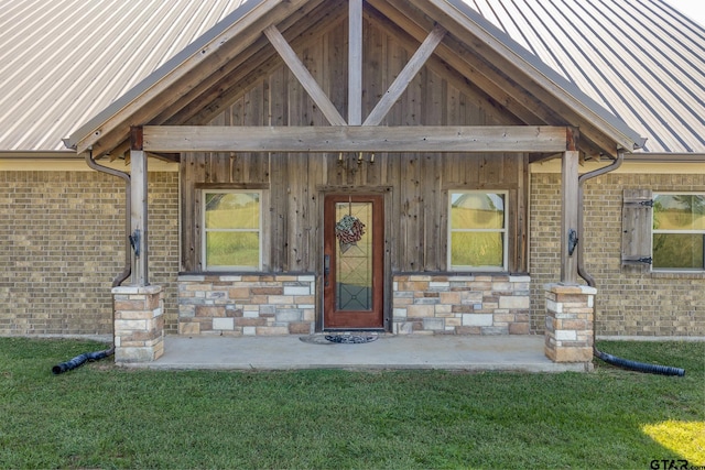 doorway to property with a lawn