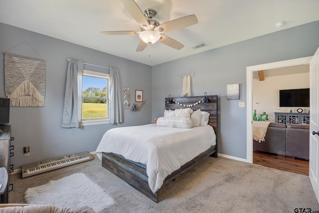 bedroom featuring ceiling fan and carpet