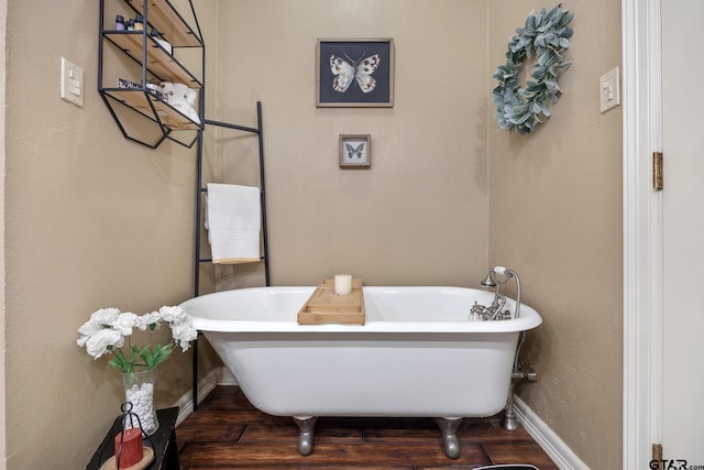 bathroom with hardwood / wood-style flooring and a tub to relax in