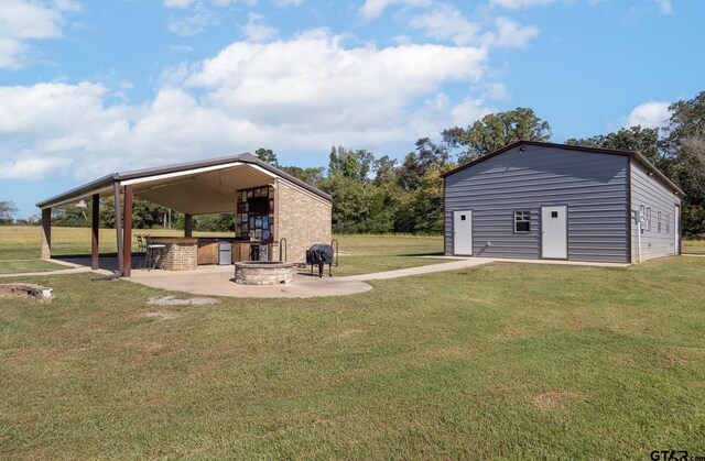 view of yard featuring a patio and an outdoor fire pit