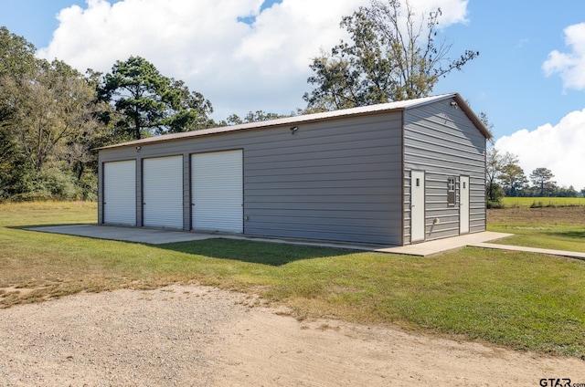 garage featuring a lawn